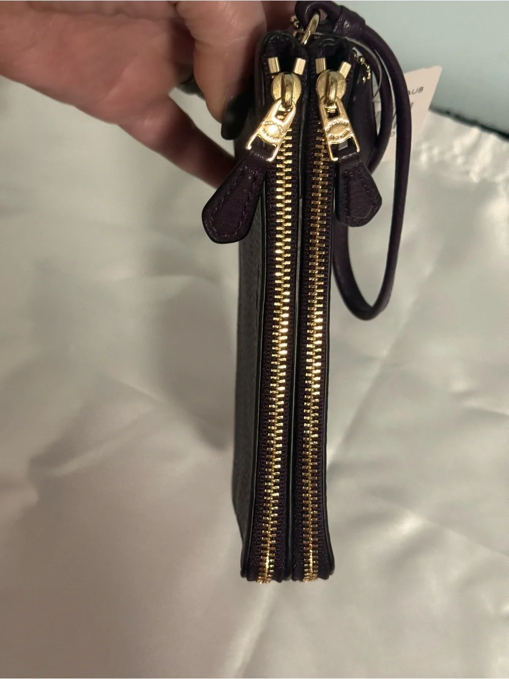 Coach NWT Pebbled Leather Wristlet in Plum w/handtag and two zip compartments.